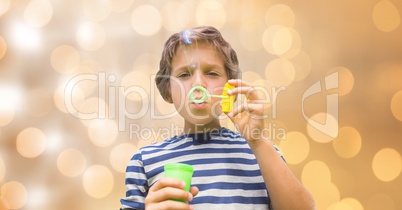 Little boy playing with soap bubbles