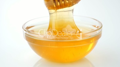 Honey pouring from drizzler into the bowl