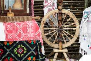 Vintage wooden spinning wheel and household items.