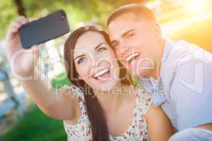 Happy Mixed Race Couple Taking Self Portrait with A Smart Phone