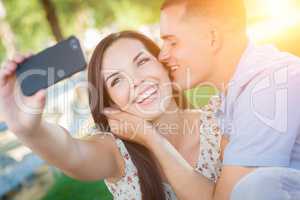 Happy Mixed Race Couple Taking Self Portrait with A Smart Phone