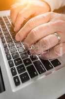 Male Hands Typing on Laptop Computer Keyboard.
