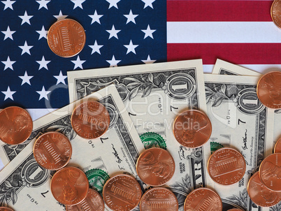 Dollar notes and coins and flag of the United States