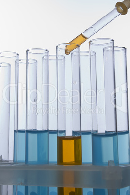 Dropper dropping liquid into test tube