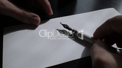 The artist inserts the pen in calligraph