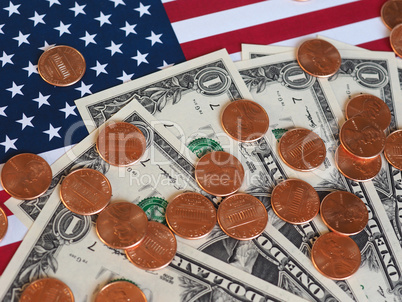 Dollar notes and coins and flag of the United States