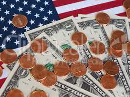 Dollar notes and coins and flag of the United States