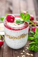 Fresh cherry yogurt with oats and chia seeds, healthy breakfast