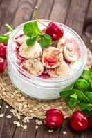 Fresh yogurt with cherry, banana and oats, healthy breakfast