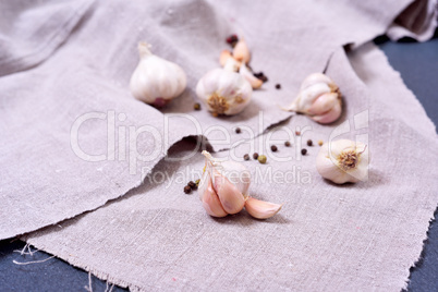 White garlic on a gray textile napkin,