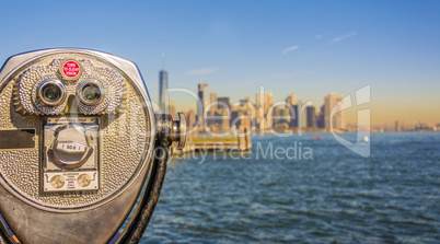 Close up of tower viewer binoculars with blurred New York City s