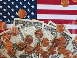 Dollar notes and coins and flag of the United States