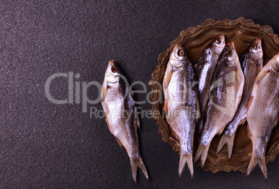 Dried in salt fish ram on a copper tray