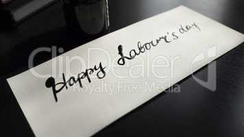 Happy labour's day calligraphy and lattering post card. Left view.