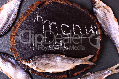 Cured river fish ram on a wooden hemp