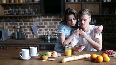 Hipster couple relaxing in the kitchen in morning