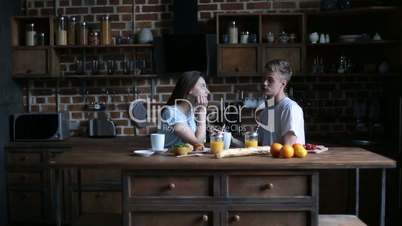 Happy couple spending morning together in kitchen