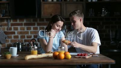 Couple eating breakfast in the morning in kitchen