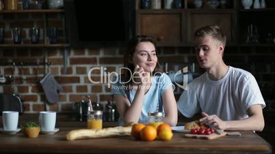 Positive couple spending leisure together at home