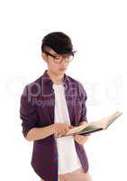 Young Asian man reading book.