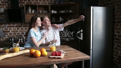 Affectionate couple relaxing and making selfie