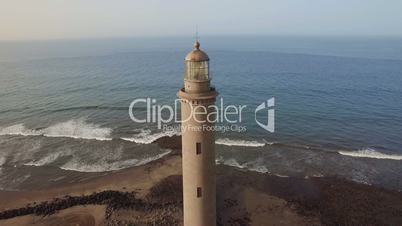 Flying over Maspalomas Lighthouse and ocean
