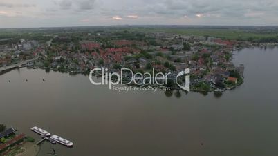 Flying over riverside township in Netherlands