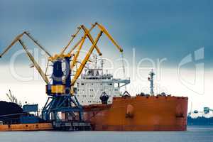 Large orange cargo ship loading