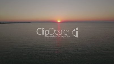 Aerial view of sea with pier at sunset