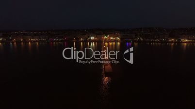 Aerial night view of resort and pier in the sea