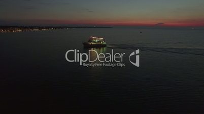 Aerial view of sailing touristic ship at night