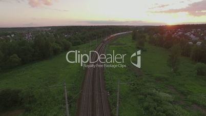 Cargo train crossing countryside at sunset, Russia