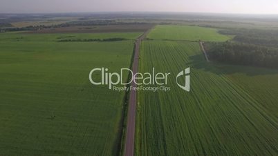 Flying over the roads among green fields, Russia