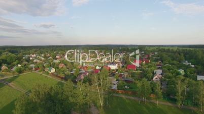 Aerial shot of village, highway and green nature in Russia