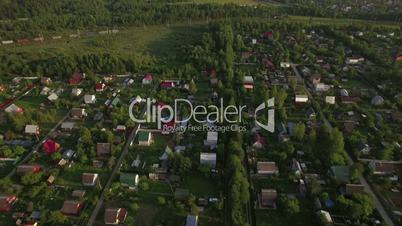 Flying over village houses and moving cargo train
