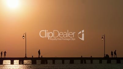 Timelapse of people traffic on the pier at sunset