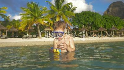 Boy diving and making photos with waterproof camera