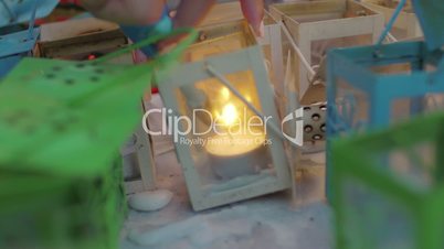 Lighting candles in street lanterns