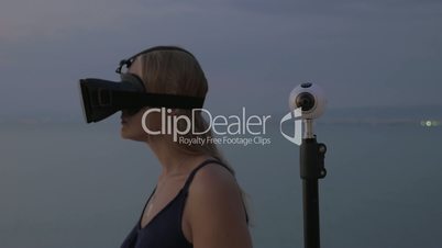 Woman in VR-headset and 360 degree camera