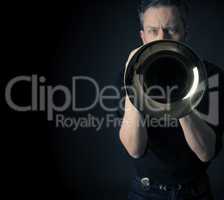 Dark portrait of a brass musician