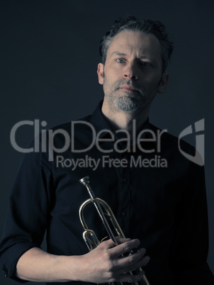 Dark portrait of a brass musician