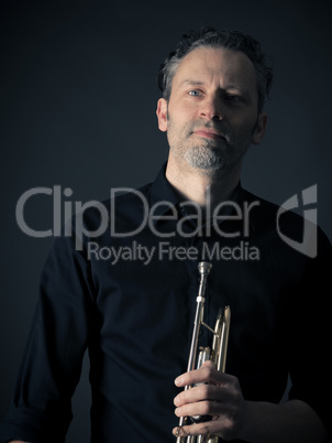 Dark portrait of a brass musician