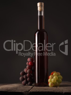 Bottle of red wine with grapes