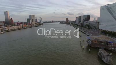 Aerial view of cityscape with modern buildings on the river against cloudy sky, Rotterdam, Netherlands