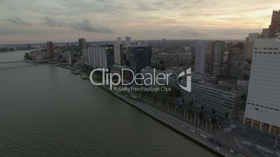 Aerial view of cityscape with modern buildings on the river against cloudy sky