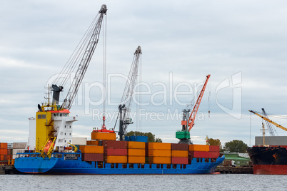 Blue container ship loading