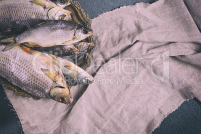 Dried fish on a copper plate, top view