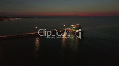 Aerial view of pontoon on the sea and people walking on it from cruise boat at the evening, Greece