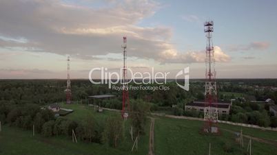 View of forest, country houses and base stations against blue sky with clouds in daylight at summer, Russia