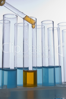 Dropper dropping liquid into test tube